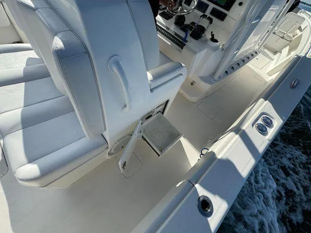 Slide: The Image of 2015 Invincible 39 Open Fisherman boat interior with white seating and control panel. - 35