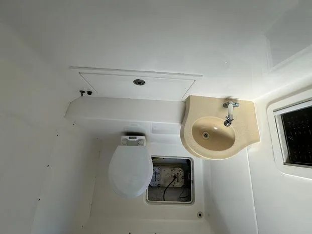 Slide: The Image of 2015 Invincible 39 Open Fisherman boat bathroom with toilet and sink. - 38
