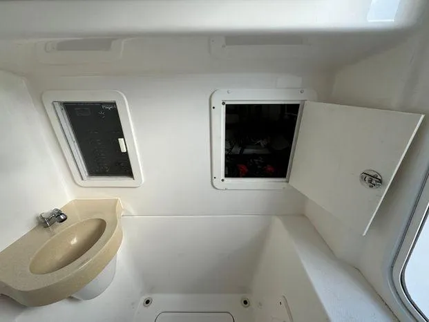 Slide: The Image of 2015 Invincible 39 Open Fisherman interior with sink and storage compartments. - 43