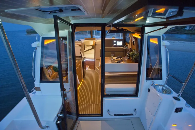 Slide: The Image of 2026 Ranger Tugs R-29S interior view with elegant lighting and modern design. - 10