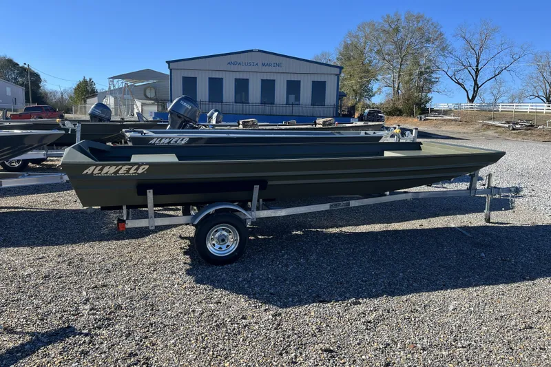 Slide: The Image of 2026 Alweld 1648 Marsh Jon boat on trailer, parked outdoors at dealership. - 7