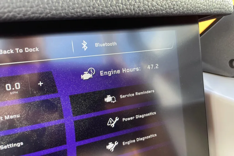 Slide: The Image of 2024 Nautique Super Air Nautique G23 Paragon dashboard displaying engine hours and diagnostics. - 14