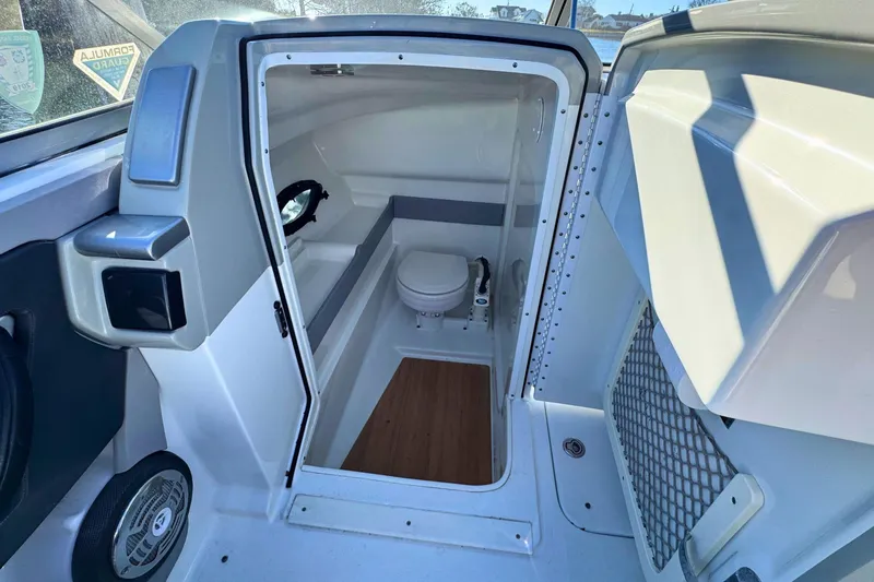 Slide: The Image of Interior of 2012 Formula 270 Bowrider boat showing compact bathroom with toilet. - 13