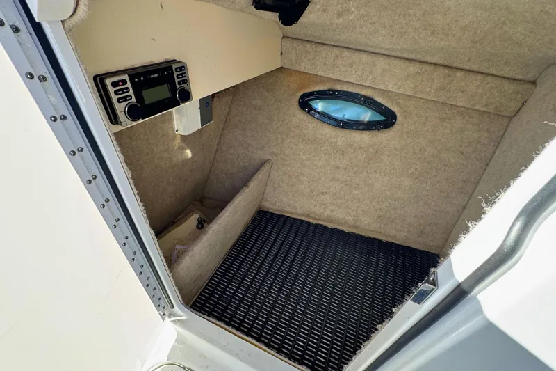 Slide: The Image of Interior cabin of a 2012 Formula 270 Bowrider boat with radio and porthole. - 14