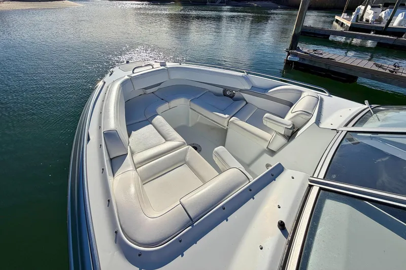 Slide: The Image of 2012 Formula 270 Bowrider boat with spacious seating, docked on calm water. - 15