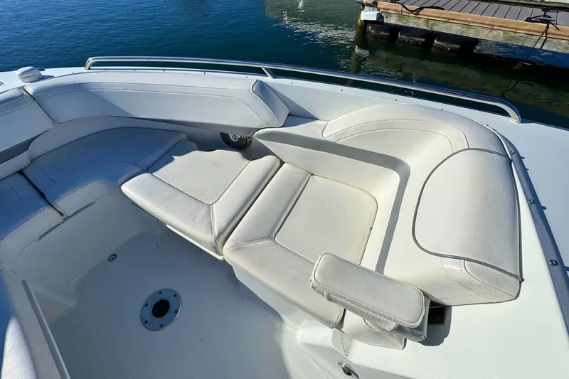Slide: The Image of 2012 Formula 270 Bowrider boat interior with white seating near dock. - 18