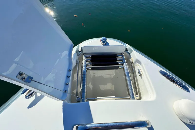 Slide: The Image of 2012 Formula 270 Bowrider boat with open storage compartment on calm water. - 20