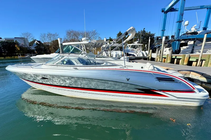 Slide: The Image of 2012 Formula 270 Bowrider boat docked in a marina under clear blue skies. - 3