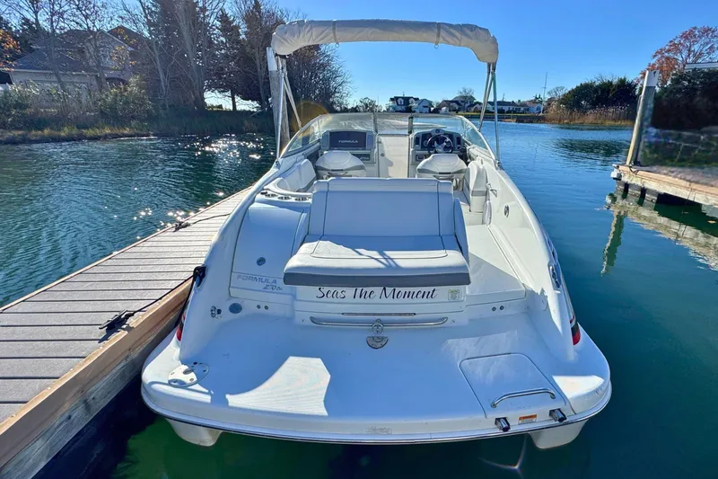 Slide: The Image of 2012 Formula 270 Bowrider boat docked on a sunny day, rear view. - 4