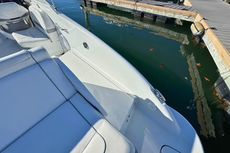 Slide: The Image of 2012 Formula 270 Bowrider boat interior near dock, showcasing seating and water. - 6