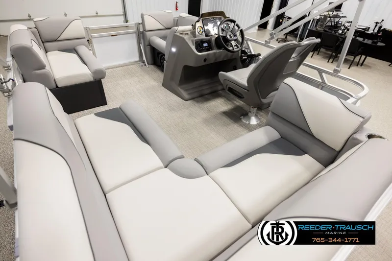 Slide: The Image of Luxurious interior of 2026 Avalon VEN CR pontoon boat with plush seating and modern helm. - 11