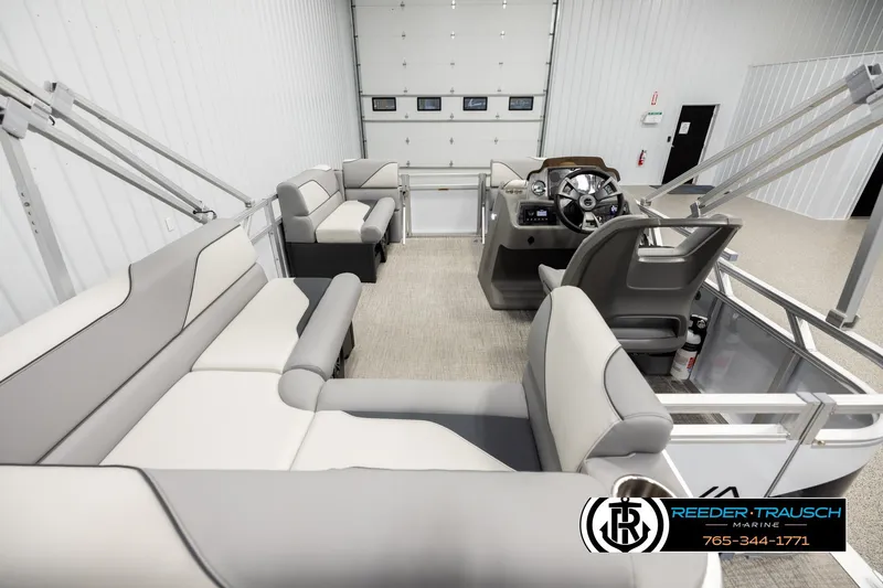 Slide: The Image of 2026 Avalon VEN CR boat interior with modern seating and steering console in a showroom. - 16