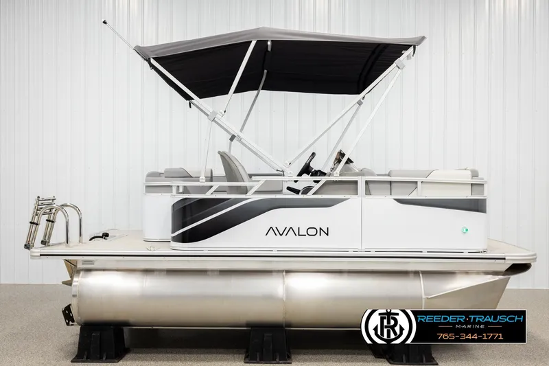 Slide: The Image of 2026 Avalon VEN CR pontoon boat with canopy, displayed indoors. - 5