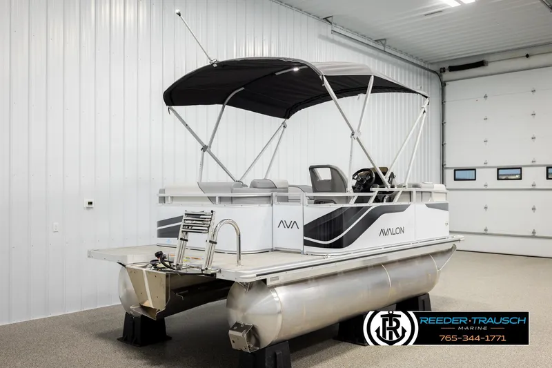 Slide: The Image of 2026 Avalon VEN CR pontoon boat in showroom with canopy and modern design. - 6