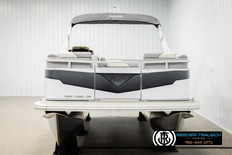 Slide: The Image of 2026 Avalon VEN CR pontoon boat in showroom, rear view with canopy and seating. - 8