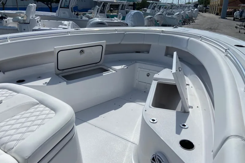 Slide: The Image of 2026 Sportsman Open 322 Center Console boat interior with storage compartments and seating. - 28
