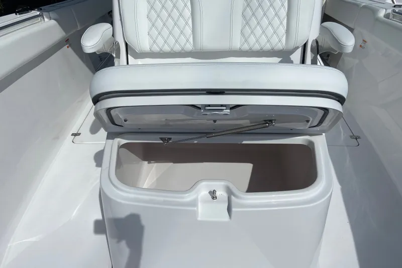 Slide: The Image of 2026 Sportsman Open 322 Center Console seat with storage compartment open. - 34