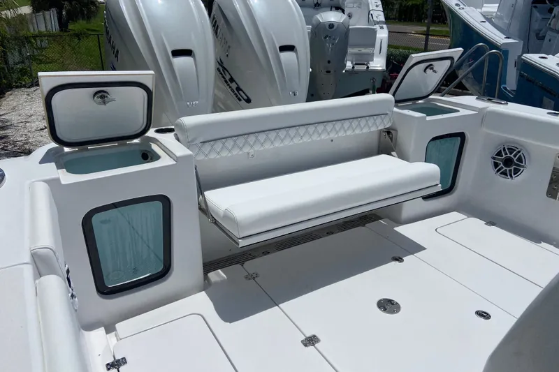 Slide: The Image of 2026 Sportsman Open 322 Center Console boat interior with seating and storage compartments. - 4