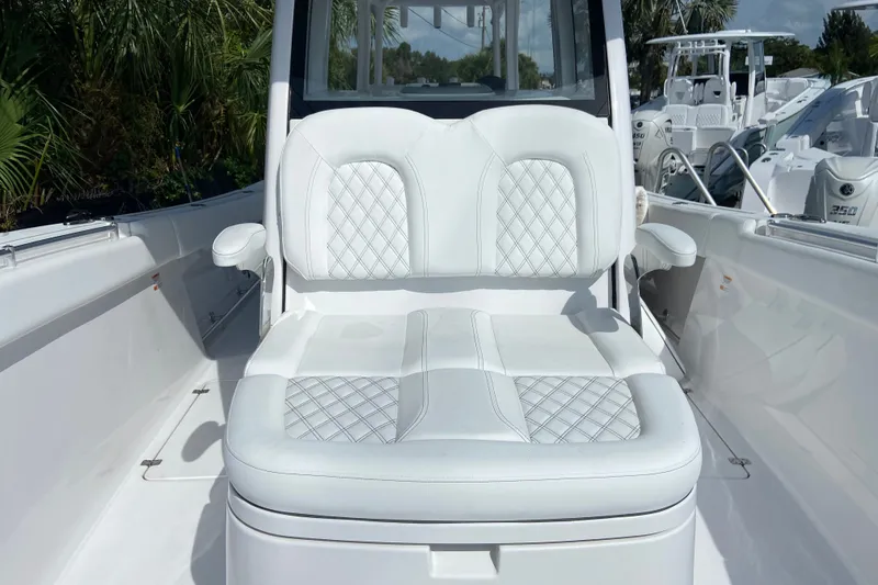 Slide: The Image of 2026 Sportsman Open 322 Center Console boat with luxurious white seating. - 33
