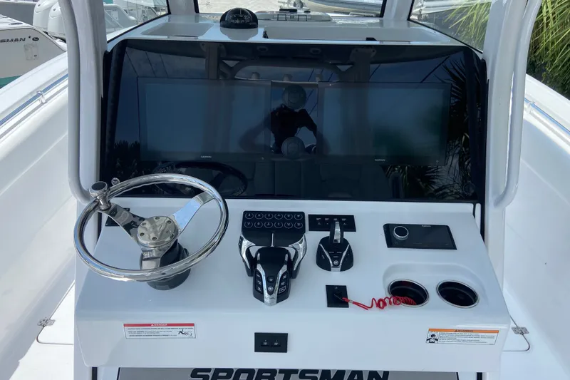 Slide: The Image of 2026 Sportsman Open 322 Center Console helm with dual screens and modern controls. - 20