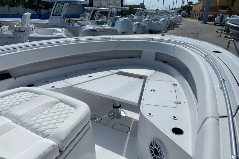 Slide: The Image of 2026 Sportsman Open 322 Center Console boat interior with seating and storage compartments. - 26