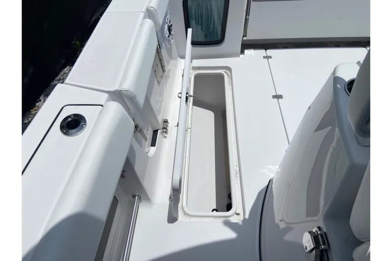 Slide: The Image of 2026 Sportsman Open 322 Center Console boat interior with open storage compartment. - 8