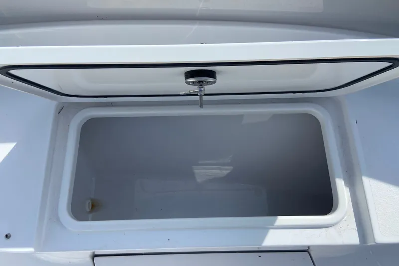 Slide: The Image of Open storage compartment on 2026 Sportsman Open 322 Center Console boat. - 29