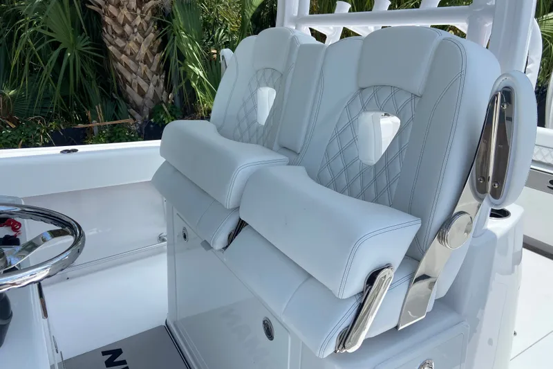 Slide: The Image of Luxury seating on 2026 Sportsman Open 322 Center Console boat, featuring elegant white upholstery. - 18