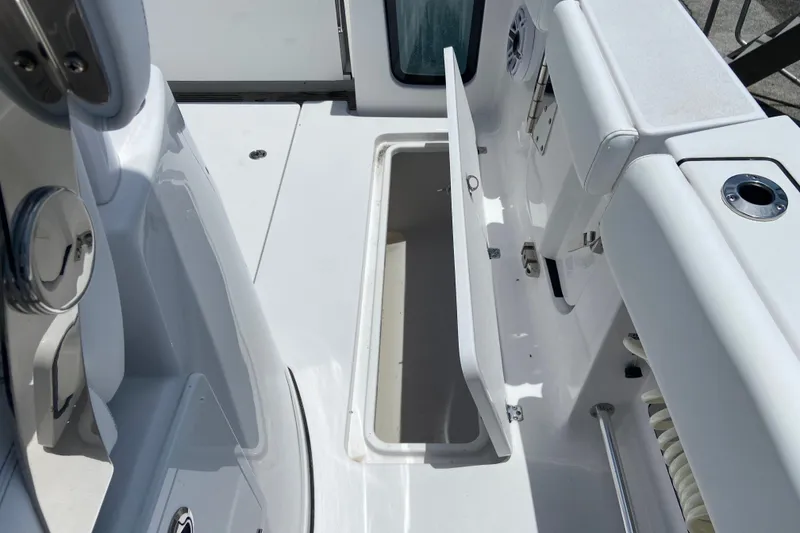 Slide: The Image of 2026 Sportsman Open 322 Center Console boat interior with open storage compartment. - 10