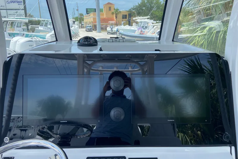 Slide: The Image of 2026 Sportsman Open 322 Center Console dashboard with dual Garmin displays. - 21