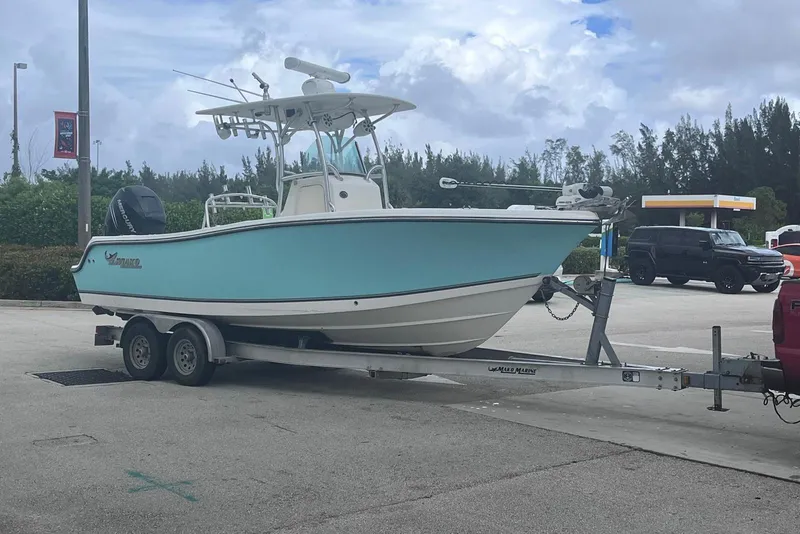 Slide: The Image of 2019 Mako 234 Center Console boat on trailer at a gas station. - 3