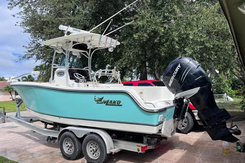 Slide: The Image of 2019 Mako 234 Center Console boat on trailer with Mercury outboard motor. - 5