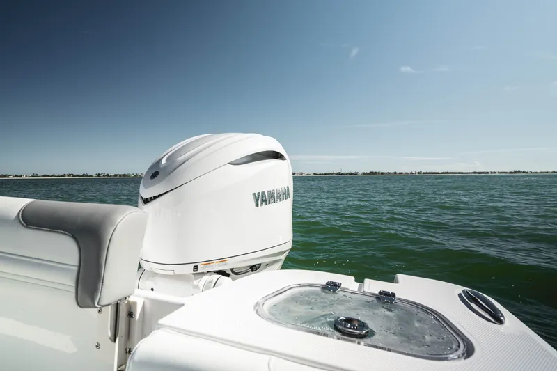 Slide: The Image of Edgewater 250CC 2026 boat with Yamaha engine on open water under clear sky. - 11