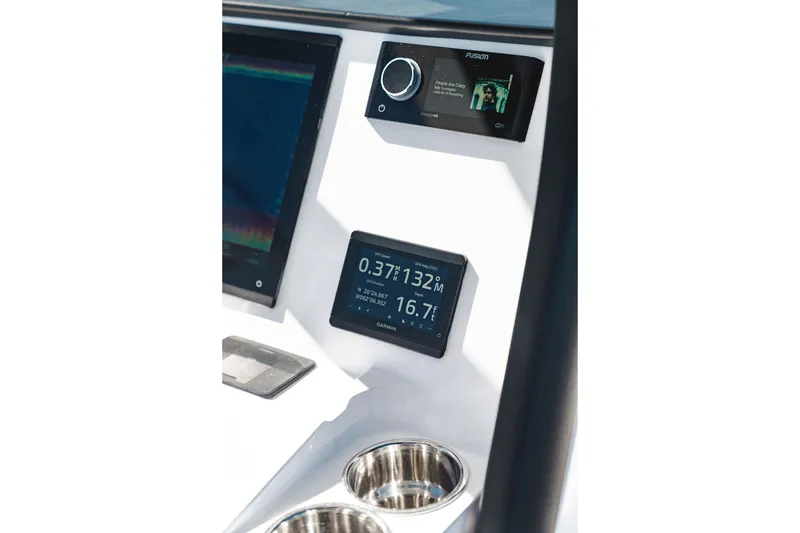 Slide: The Image of 2026 Edgewater 250CC boat cockpit with steering wheel, navigation display, and ocean view. - 4