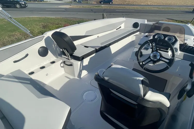 Slide: The Image of Interior view of 2026 Starcraft SV 18 OB boat, featuring steering wheel and seating. - 12