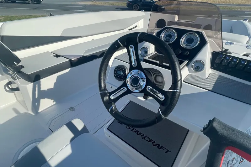 Slide: The Image of 2026 Starcraft SV 18 OB boat dashboard with steering wheel and instrument panel. - 5