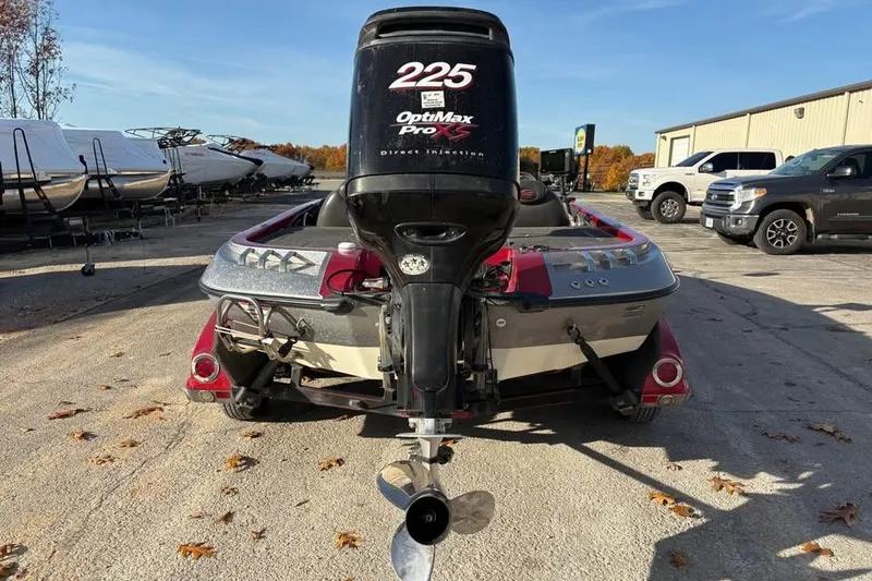 Slide: The Image of 2011 Ranger Z118 Comanche boat with OptiMax Pro XS engine in a parking lot. - 3
