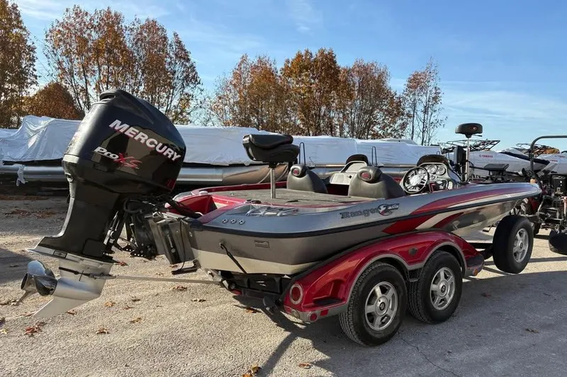 Slide: The Image of 2011 Ranger Z118 Comanche boat with Mercury Pro XS engine, parked outdoors. - 4