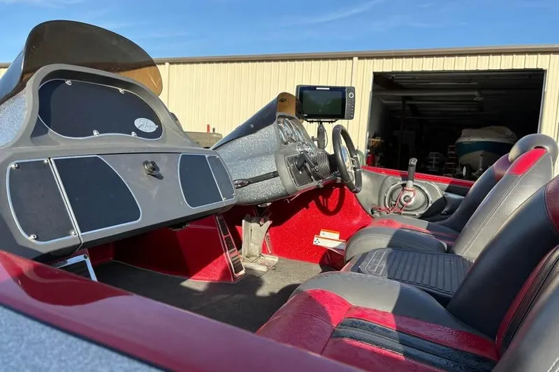 Slide: The Image of 2011 Ranger Z118 Comanche boat interior with steering wheel and seating. - 7