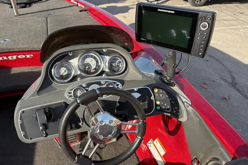 Slide: The Image of 2011 Ranger Z118 Comanche boat dashboard with steering wheel and Humminbird fish finder. - 8