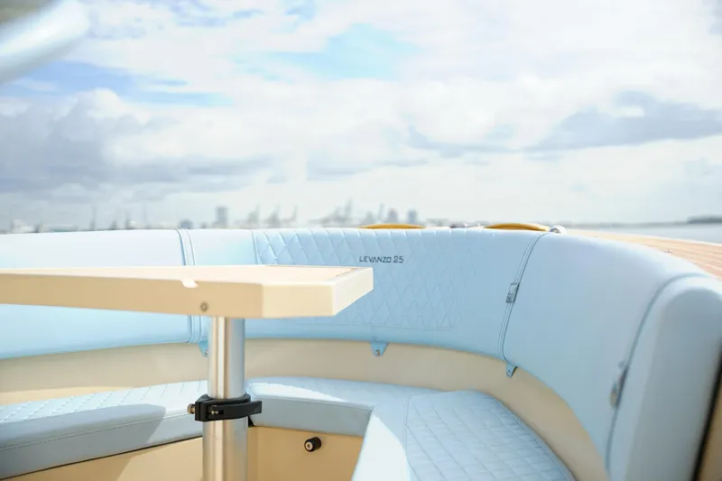 Slide: The Image of 2026 Lilybaeum Levanzo 25 Lounge Deck with light blue seating and table, ocean view. - 11