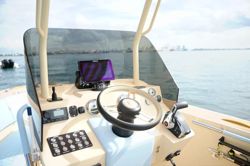 Slide: The Image of Steering console of 2026 Lilybaeum Levanzo 25 Lounge Deck boat on calm water. - 13