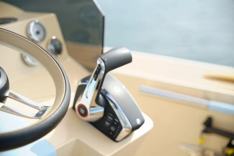Slide: The Image of Close-up of 2026 Lilybaeum Levanzo 25 Lounge Deck steering wheel and throttle controls. - 16