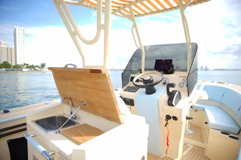 Slide: The Image of 2026 Lilybaeum Levanzo 25 Lounge Deck boat interior with steering console and kitchenette. - 18
