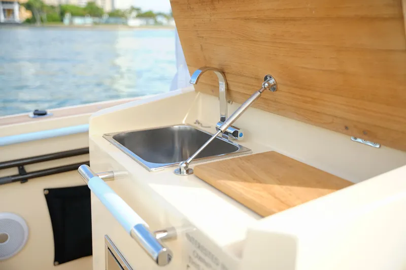 Slide: The Image of Lilybaeum Levanzo 25 Lounge Deck 2026 boat sink and cutting board on deck. - 19