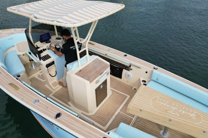 Slide: The Image of 2026 Lilybaeum Levanzo 25 Lounge Deck boat with striped canopy on calm water. - 21