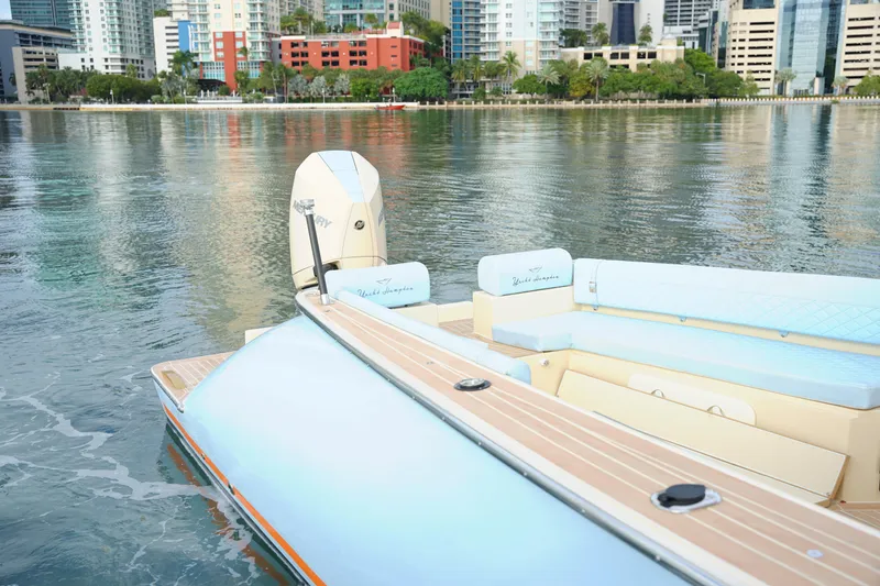 Slide: The Image of 2026 Lilybaeum Levanzo 25 Lounge Deck boat on calm water with cityscape background. - 23