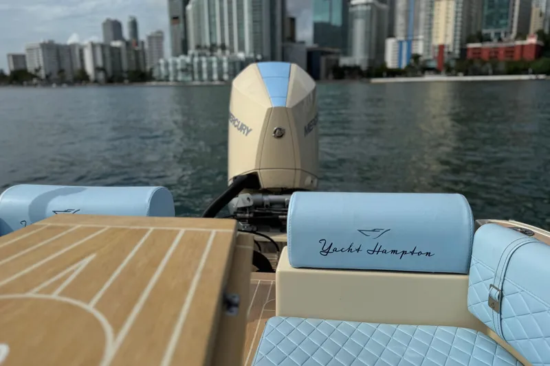 Slide: The Image of 2026 Lilybaeum Levanzo 25 Lounge Deck boat with city skyline in background. - 28