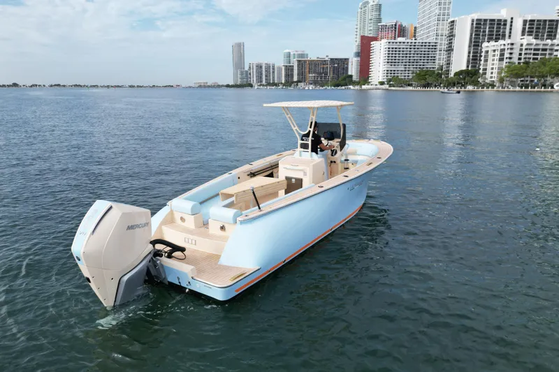 Slide: The Image of 2026 Lilybaeum Levanzo 25 Lounge Deck boat on water, city skyline in background. - 6