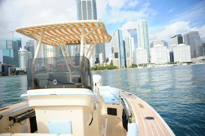 Slide: The Image of 2026 Lilybaeum Levanzo 25 Lounge Deck boat cruising near city skyline. - 9